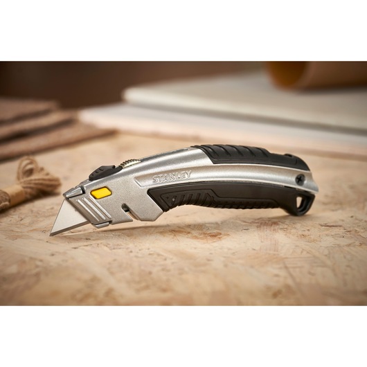 STANLEY 0-10-788 utility knife with silver and black body, angled on work surface.