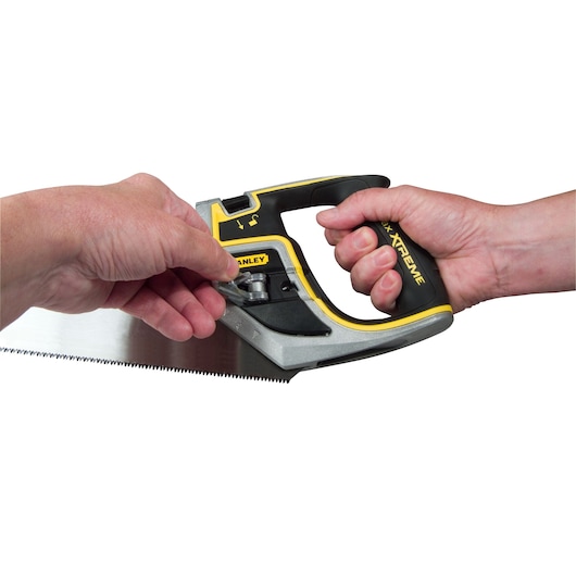 Photo of STANLEY 0-20-104 hand saw being adjusted, close-up on handle and blade mechanism.