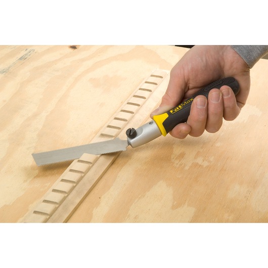 STANLEY 0-20-331 FatMax folding saw being used for woodworking, close-up of handle and blade.