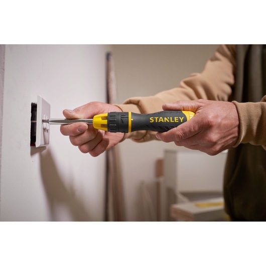 Photo of STANLEY 0-68-010 screwdriver used to install a wall outlet, close-up view.