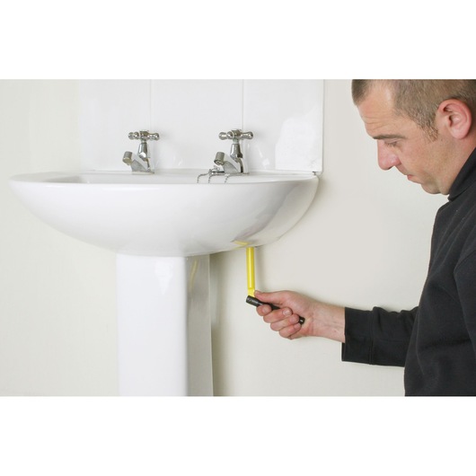 STANLEY 0-70-453 angle screwdriver in use under a white bathroom sink, side view.