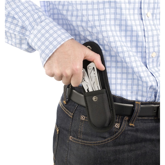 STANLEY 0-84-519 multi-tool in black belt pouch, shown being removed by hand, close-up side angle.