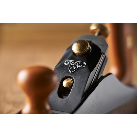 Photo of STANLEY 1-12-136 hand plane, close-up showing branded logo, brass fittings, and wooden handle.