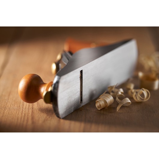 STANLEY 1-12-136 woodworking hand plane photographed close-up on wooden surface with wood shavings.