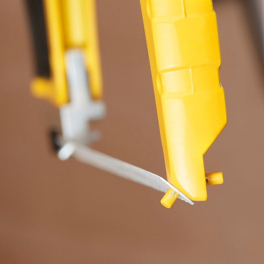 STANLEY 1-20-110 hacksaw close-up showing yellow frame and blade tension adjuster.