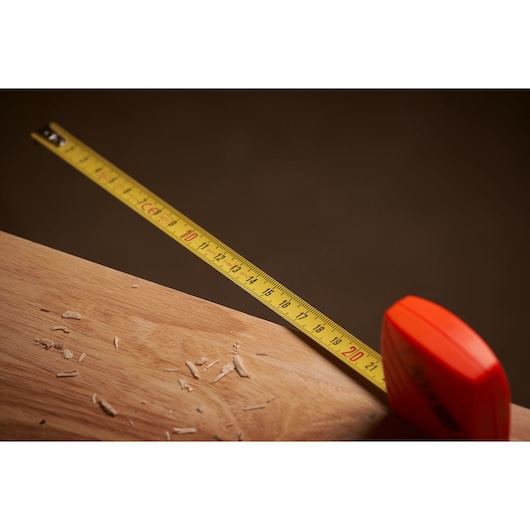 STANLEY 1-30-299 tape measure in use on wood surface, close-up photography.