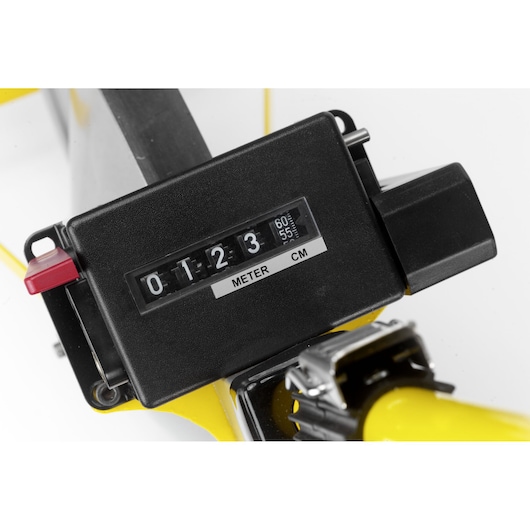 Close-up of a black metric measuring device with meter and centimeter display attached to a yellow tool.
