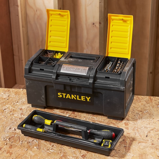 Photo of STANLEY 1-79-217 black and yellow toolbox with open compartments, tray with hand tools, on wooden surface.