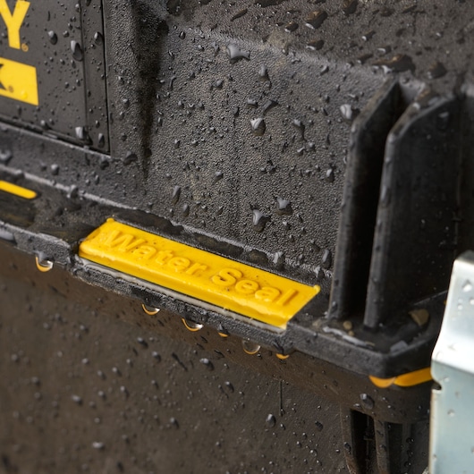 STANLEY 1-93-935 toolbox close-up with yellow water seal, covered in water droplets.