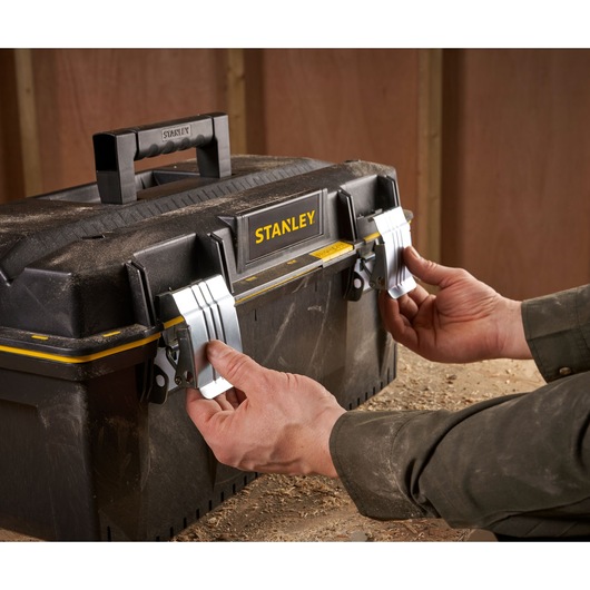 STANLEY 1-94-749 toolbox with metal latches, photography of hands opening the box in workshop.