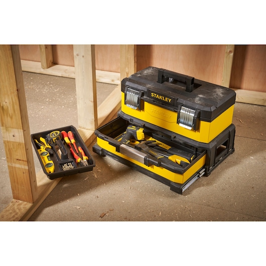 STANLEY 1-95-829 yellow and black toolbox with open tray showing hand tools, photography on worksite.
