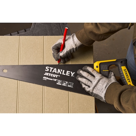 Photography of STANLEY 2-20-180 hand saw with yellow and black handle used for marking cut on board.