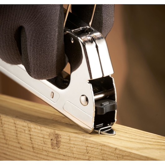 STANLEY 6-TR45 stapler in use on wood, close-up photography showing silver metal finish.