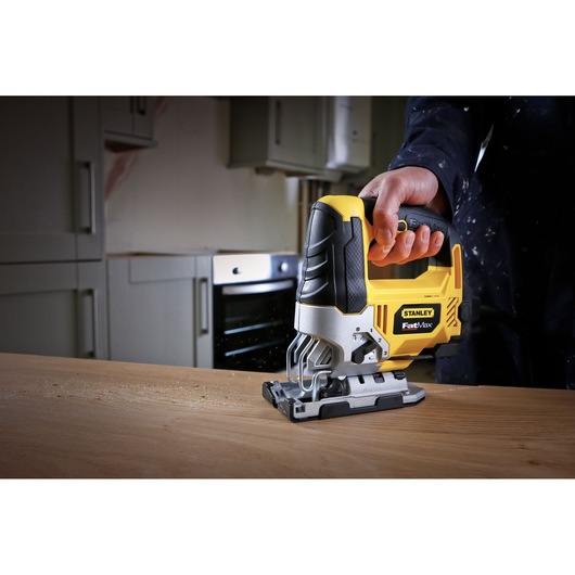 STANLEY FME340K jigsaw power tool in use on wood, close-up angle, yellow and black design.