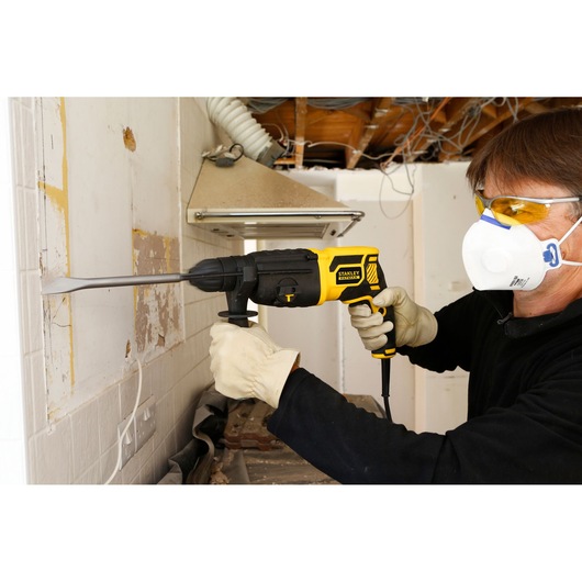 STANLEY FME500K FATMAX SDS-Plus Hammer being used to chisel wall tiles in a renovation setting.