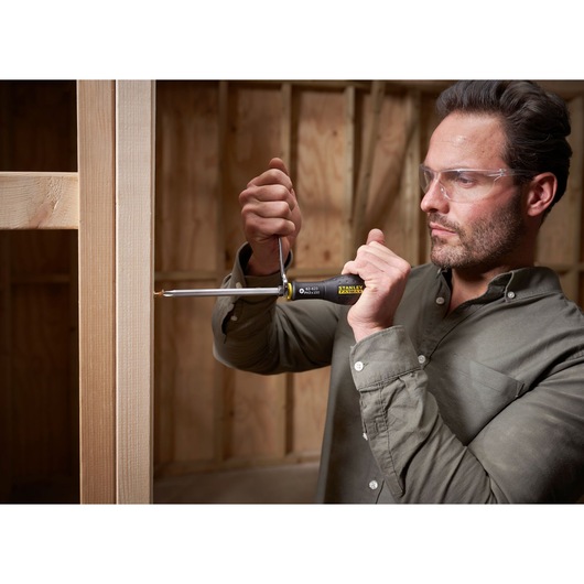 STANLEY FMHT0-62623 screwdriver in use for woodworking, close-up photo, product held in hand.