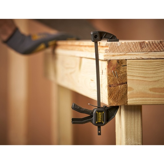 STANLEY FMHT0-83231 photography of bar clamp securing wooden workbench edge