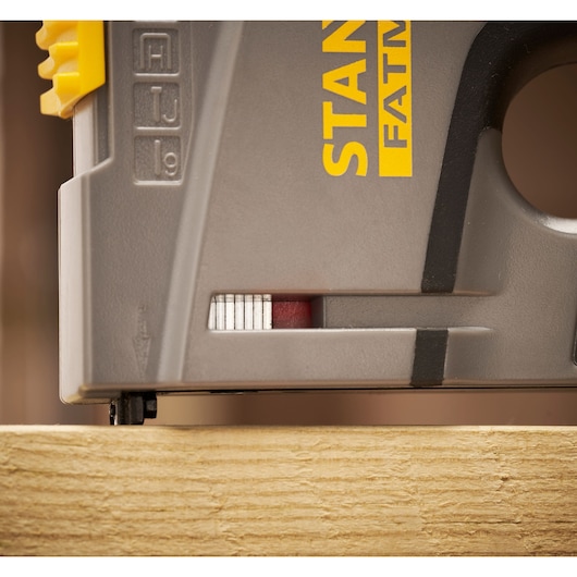Photo of STANLEY FMHT6-70868 stapler side view showing detail on wood surface.
