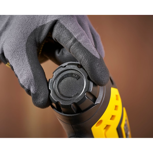 STANLEY FMHT6-75934 close-up photography of black and yellow tool handle with adjustment cap held by glove.