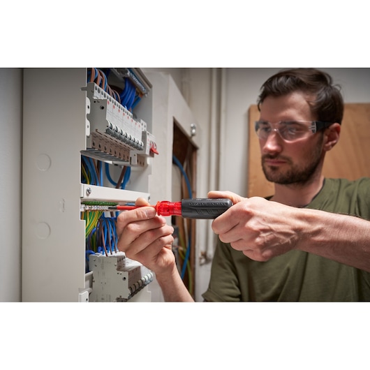 Photo of STANLEY FMHT66426-0 screwdriver used on electrical panel, close-up on tool and wiring.