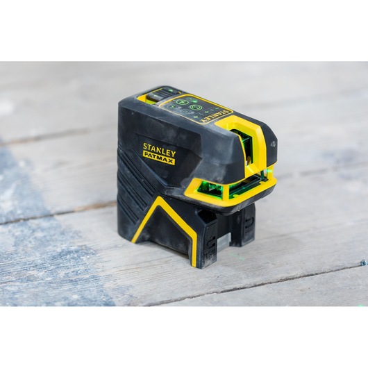 STANLEY FMHT77598-1 laser level, black and yellow, photography of tool on wooden surface.