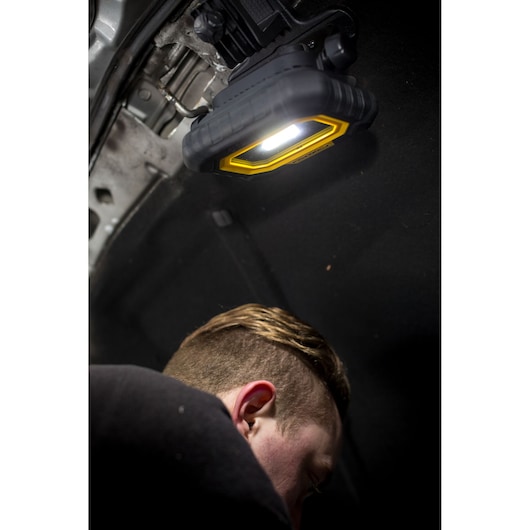 STANLEY FMHT81507-1 work light mounted under car hood, illuminating engine area during repair.