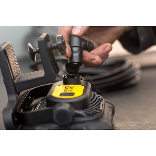 Photo of STANLEY FMHT81507-1 inflator clamp and hose connector in close-up view.
