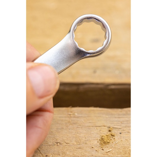 STANLEY FMMT13034-0 combination wrench close-up held over wooden surface.