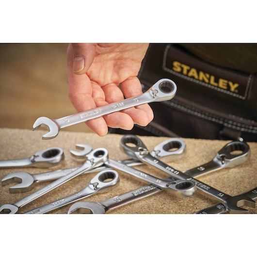 STANLEY FMMT13089-0 hand-held combination ratchet wrench set on workbench, close-up photo.