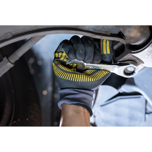 STANLEY FMMT13109-0 photography of gloved hand using ratcheting wrench on car part.