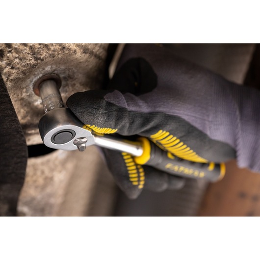 Photo of STANLEY FMMT17192-0 ratchet wrench used on a bolt by a gloved hand, product category: photography.