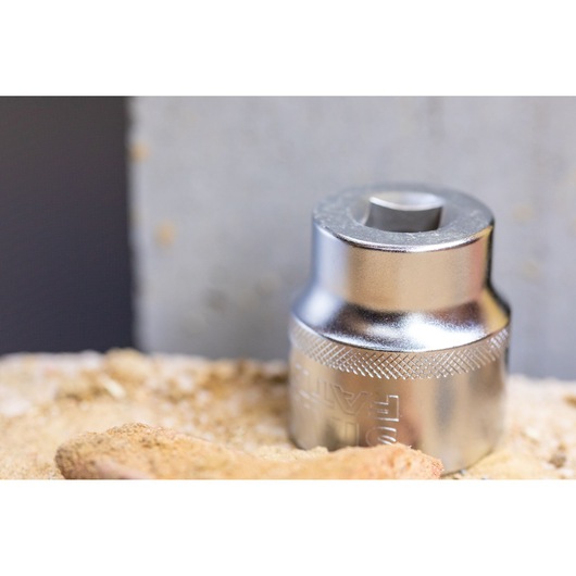 STANLEY FMMT17208-0 chrome socket, close-up photography, on a sandy surface.