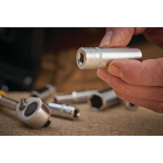 Stanley FMMT17300-0 socket held in hand, with chrome finish and other sockets in the background.