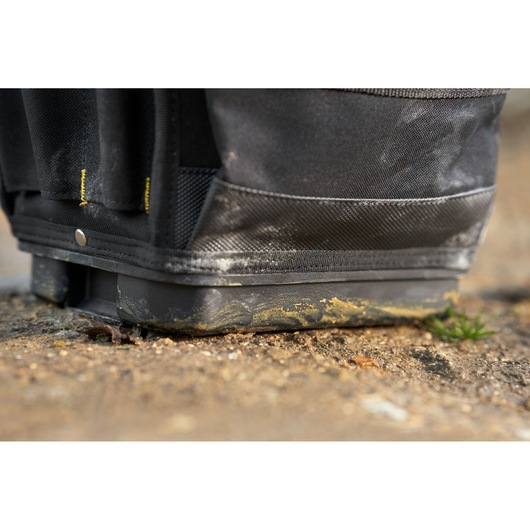 STANLEY FMST17624-1 tool bag base with dirt, close-up view showing rugged black fabric and reinforced bottom.