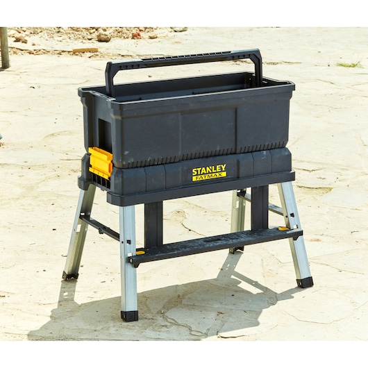 Stanley FMST81083-1 black toolbox on folding metal stand, outdoor angle.