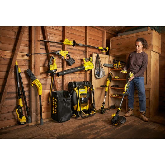STANLEY SFMCCS630B garden power tools displayed in shed, including trimmer, blower, and accessories.