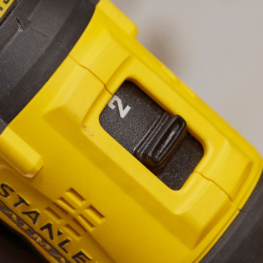 STANLEY SFMCD710C2K drill close-up showing black speed selector switch and yellow housing.