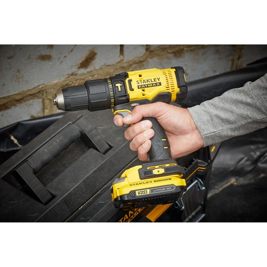 STANLEY SFMCD711C2K cordless drill with yellow and black design, FATMAX branding, handheld side angle.