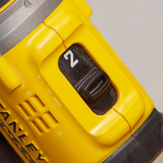 STANLEY SFMCD720B cordless drill close-up showing yellow housing and black speed selector switch.