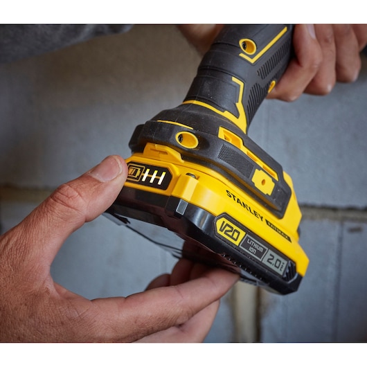 Photo of STANLEY SFMCD721D2K cordless drill base with V20 lithium-ion 2.0Ah battery held by hands.