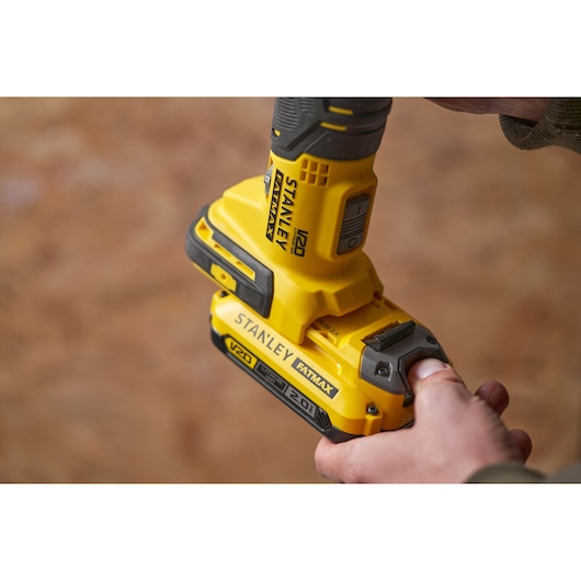 STANLEY SFMCE500D2K yellow cordless drill close-up showing battery attachment.