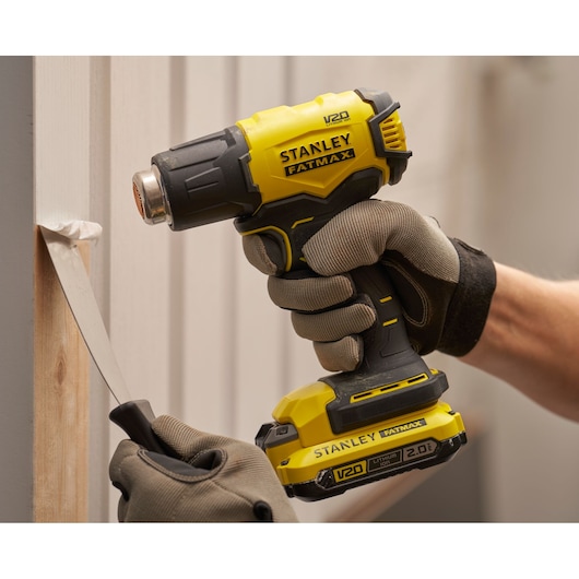 Stanley SFMCE530B heat gun used to remove paint, close-up of tool in use, photography category.