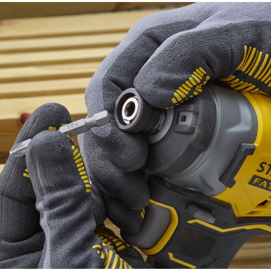 STANLEY SFMCF820D2K impact driver front angle, gloved hand inserting screwdriver bit