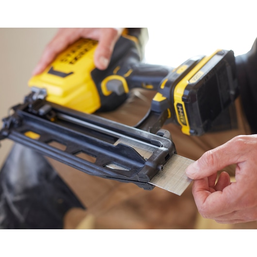 STANLEY SFMCN616D2K cordless nailer, close-up angle, showing nails being loaded into the tool.