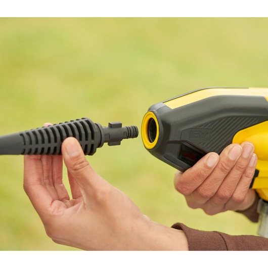 STANLEY SFMCPC93B portable washer nozzle connection, close-up, yellow and black housing in hand.