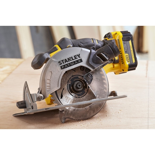 STANLEY SFMCS500B cordless circular saw, side angle, yellow and black, in use on wood surface