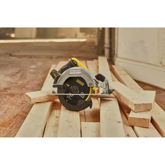 STANLEY SFMCS550M2K circular saw on wooden planks, front angle, photography for product category.