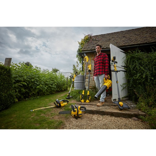 STANLEY SFMCST933M1 garden tools set in outdoor photography, including trimmer, blower, and hedge trimmer.