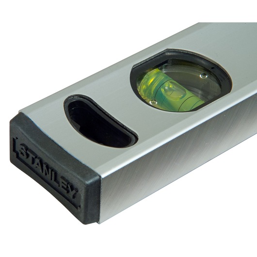 Close-up of a Stanley spirit level with a visible bubble vial and rubber end cap.
