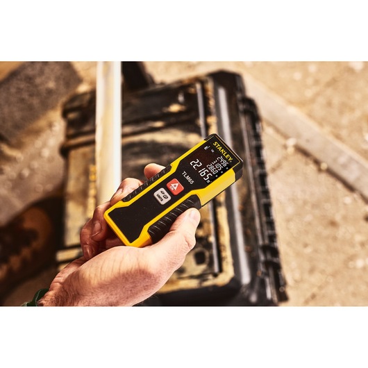 Stanley STHT1-77032 yellow-black laser distance measurer, held in hand, photography product category